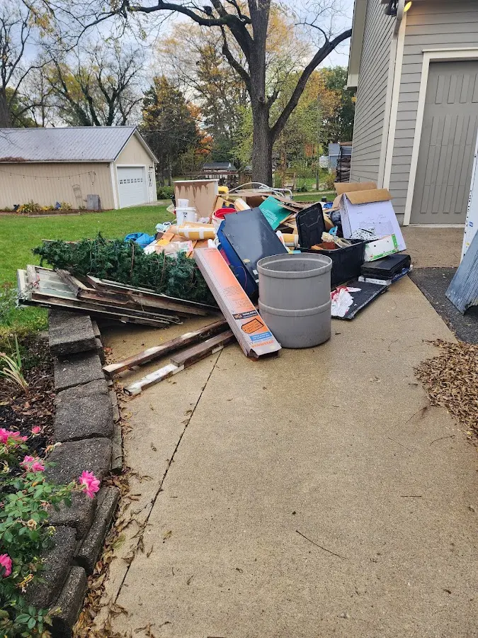 Dumpster being loaded with debris for Estate Cleanout Dumpster Rental in Sunland Park